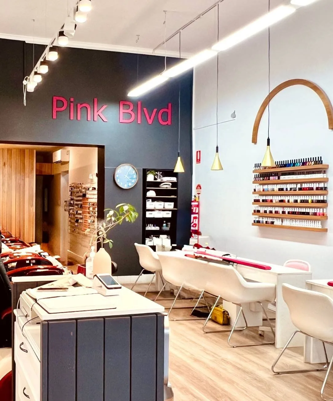 The manicure stations and colour wall inside Pink Boulevard